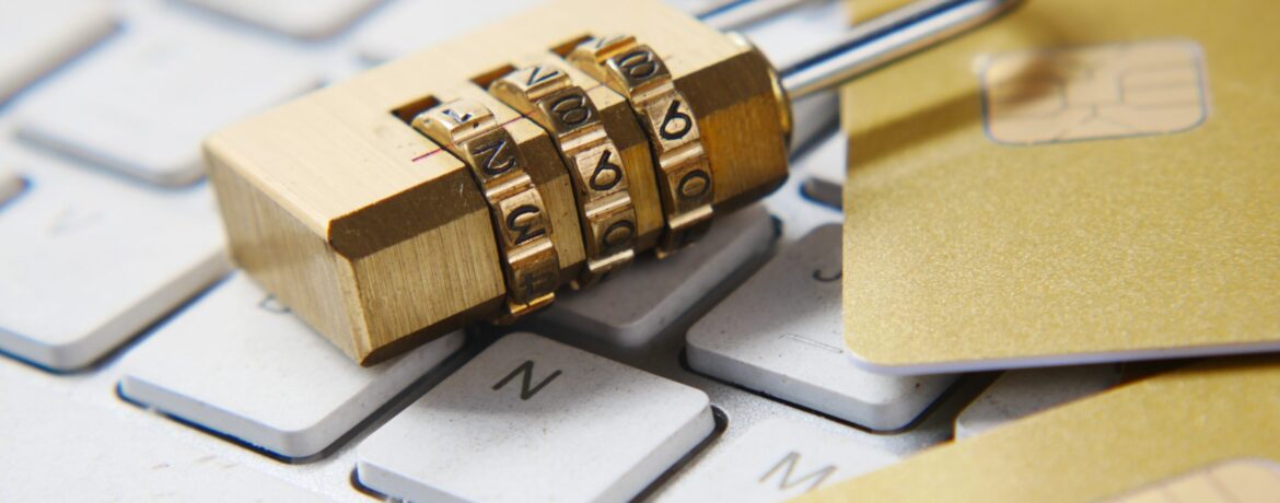 a golden padlock sitting on top of a keyboard