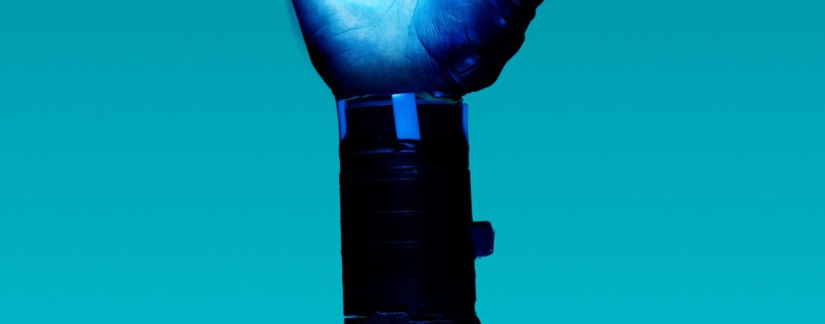 alt="Free Prosthetic Arm on Blue Background Stock Photo"